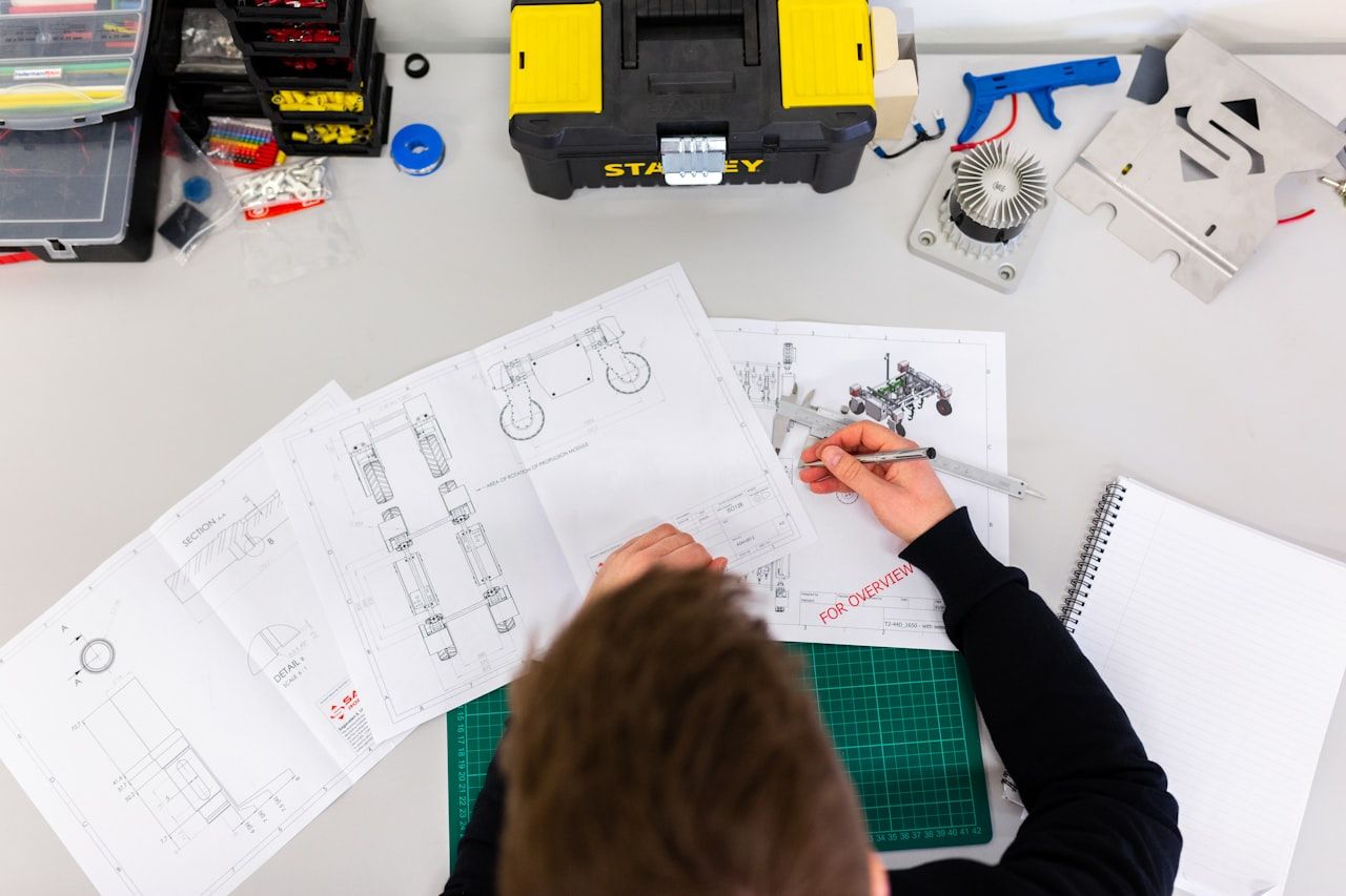 Electronics product development workspace with tools and prototypes